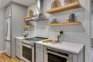 Modern Kitchen with Subway Tile Backsplash, Open Shelving, Stainless Steel Appliances, and Wooden...