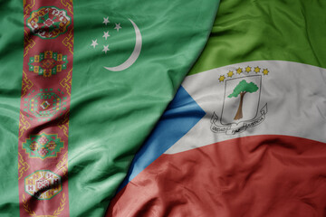big waving national colorful flag of equatorial guinea and national flag of turkmenistan.