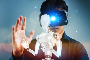 A man is wearing a virtual reality headset and interacting with a robot. The robot is white and has a blue eye. Concept of futuristic technology