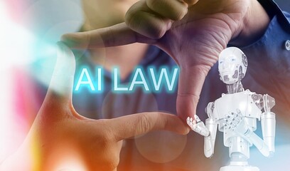 A robot is shown with the words AI law written in the air above it. The robot is a symbol of...