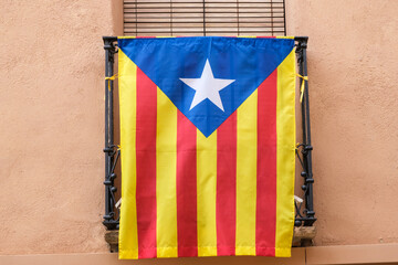 Estelada Vermella, Catalan nationalist flag, placed on balconies of a town in the interior of...