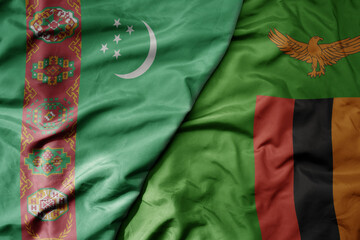 big waving national colorful flag of zambia and national flag of turkmenistan.