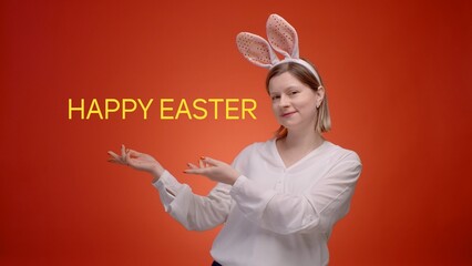 Woman in Easter bunny's ears on red background with free copy space for text of congratulation or invitation for celebrating Easter.