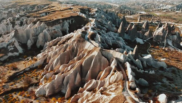 Cappadocia, a semi arid region in central Turkey, is known for its distinctive fairy chimneys tall, cone-shaped rock formations clustered in Monks Valley	
