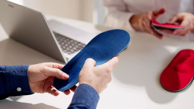 Orthopedist Doctor With Orthopedic Shoe Insole Consulting