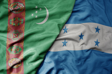 big waving national colorful flag of honduras and national flag of turkmenistan.