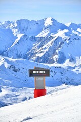 Meribel sign on snowy mountain in French alps