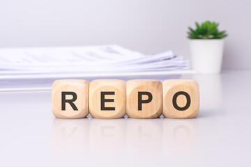 The wooden cubes displaying the text 'REPO' against a light gray background signify a focus on the...