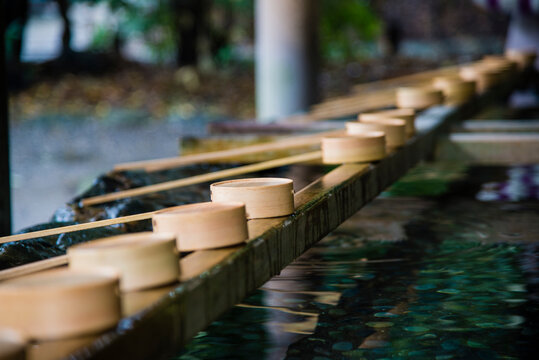 Kyoto, Japan - March 25 2016: Water ladles and wooden dippers used for a ceremonial purification in entrance of the shrine