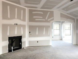 Drywall and taping interior of house construction
