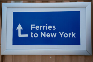 Directional Sign Pointing Towards Ferries to New York