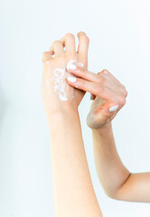 Beautiful Woman Hands. Female Hands Applying Cream, Lotion. Spa and Manicure concept. Female hands with french manicure. Soft skin, skincare concept. Hand Skin Care
