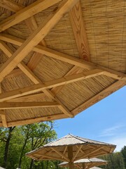 wooden umbrella against the blue sky
