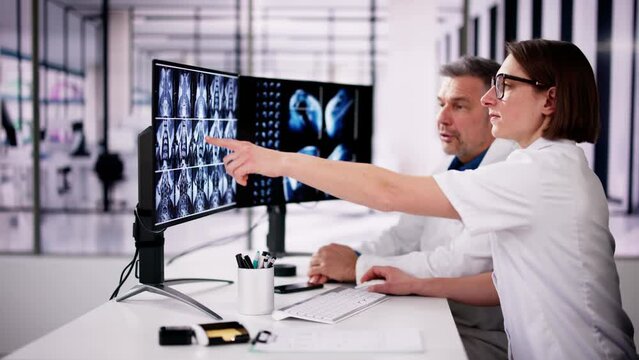 Doctors Looking At An MRI Scan At Computer