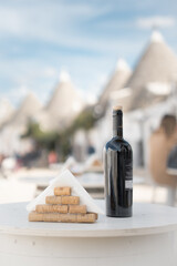 A bottle of wine on the table. Alberobello. ITALY - obrazy, fototapety, plakaty