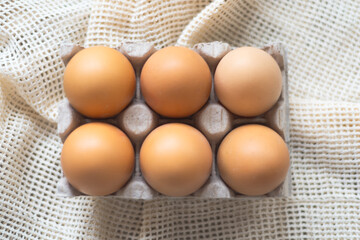 Chicken bio egs in cardboard package , selective focus. Dark green, light grey, white egs in woven basket macro. Egs on the eco bag