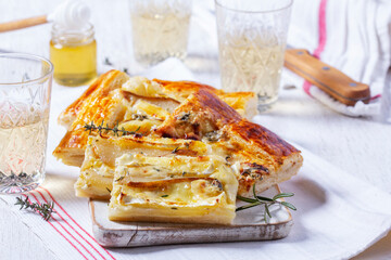 Puff pastry pie with cheese, pears, nuts and honey, served with champagne. - 764294730
