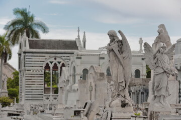 White marble sculptures topping sumptuous graves on the Avenida Cristobal Colon Avenue west side, Cementerio de Colon Cemetery. Havana-Cuba-097