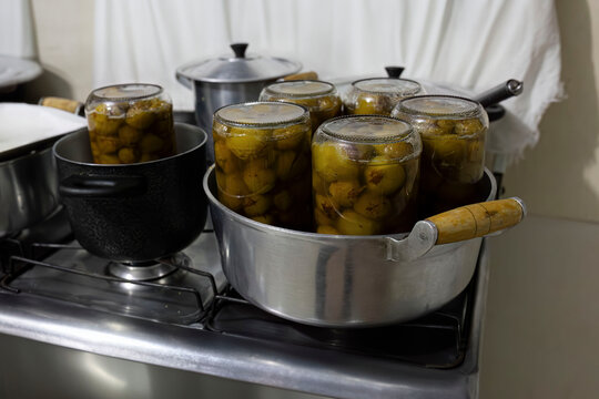 jars with mangaba jam in a pan