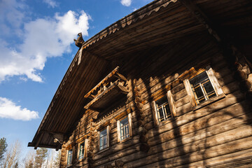 Wooden house with blue sky, fluffy clouds, and medieval architecture in the city