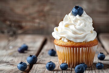 Tasty cupcake with butter cream and ripe blueberries on wooden table - obrazy, fototapety, plakaty