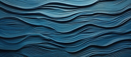 An up-close view of a wall painted in a shade of blue with wavy and flowing patterns resembling waves
