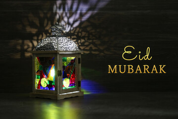 Eid Mubarak greeting card. Arabic lantern indoors at night