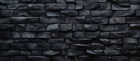 This image features a detailed view of a dark stone wall set against a solid black background