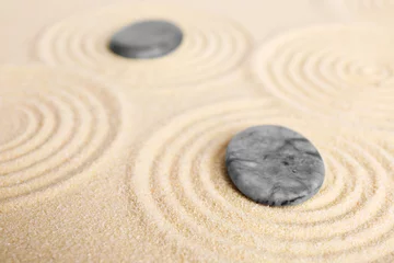 Fotobehang Zen garden stones on beige sand with pattern, closeup © New Africa