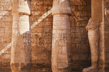 Columns with Egyptian hieroglyphs and ancient symbols. Famous Egyptian landmark. Visiting ancient Egypt - 764320754