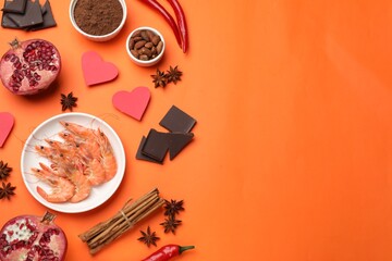 Natural aphrodisiac. Different products and paper hearts on orange background, flat lay. Space for...