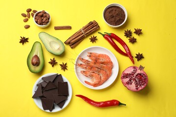 Natural aphrodisiac. Different products on yellow background, flat lay