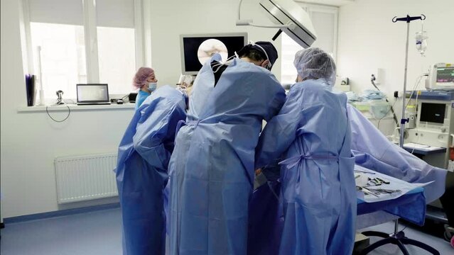 A team of surgeons at work in the operating room. Modern equipment in the operating room. The concept of modern medical technologies, surgery.