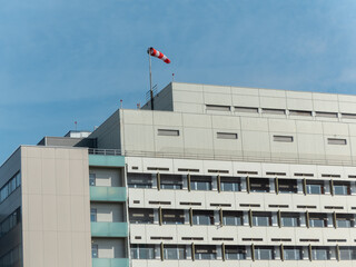 A windsock is a visual wind direction indicator on the top of the building