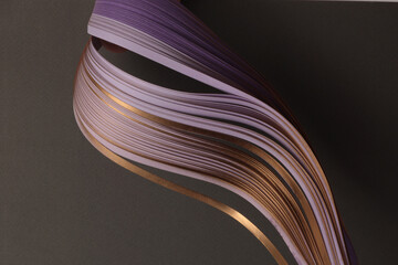 Gold bronze, violet  Color strip gradient wave paper on black. Abstract texture background.