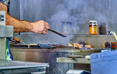 Professional Chef Grilling Steaks in an Industrial Kitchen
