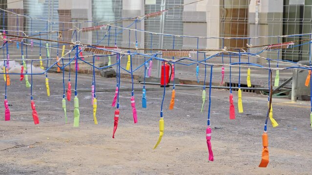 Firecrackers hanging on a thread in city street. Colorful firecrackers bouncing hanging on a thread at city street before mascleta in slow motion during Las Fallas.