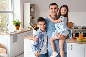 Little children with their father hugging at home