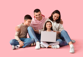 Little children with their parents and laptop on pink background