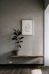A framed drawing of an abstract line art figure hangs on the wall above a minimalistic shelf. In the room is a wooden floor, plant pot, and neutral tones creating a Scandinavian-style home interior