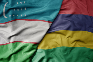 big waving national colorful flag of mauritius and national flag of uzbekistan.