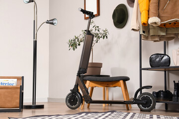Electric scooter near ottoman in stylish hall