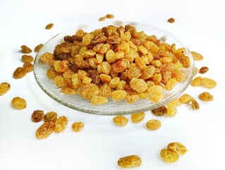 Currant fruit on a white background. Pile the dried raisins on a clear plate 
