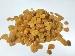 Currant fruit on a white background. Pile the dried raisins on a clear plate 