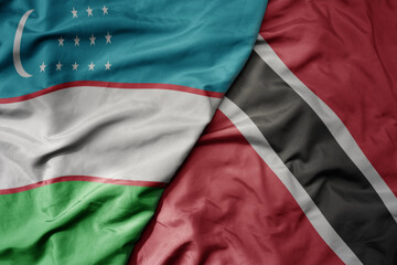 big waving national colorful flag of trinidad and tobago and national flag of uzbekistan.