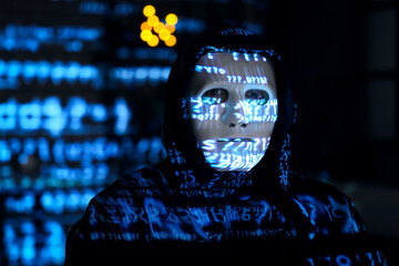 Hacker and projection of programming code in dark room, closeup