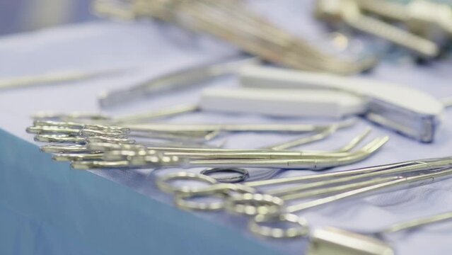 Close-up of surgical instruments in a modern surgery room. Diverse team of professional surgeons, healthcare and medical concept.