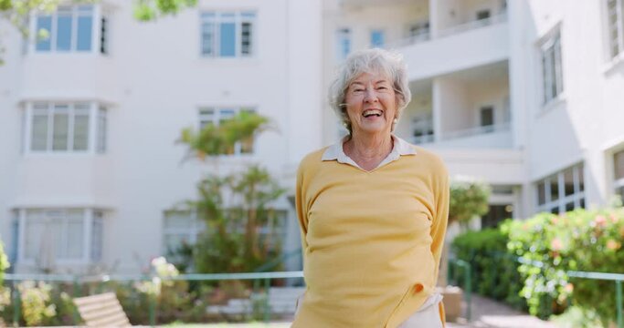 Senior woman, happy and dancing outdoors, retirement and celebrate a milestone on grass. Elderly female person, portrait and spinning on lawn of nursing home, having fun and confidence on weekend