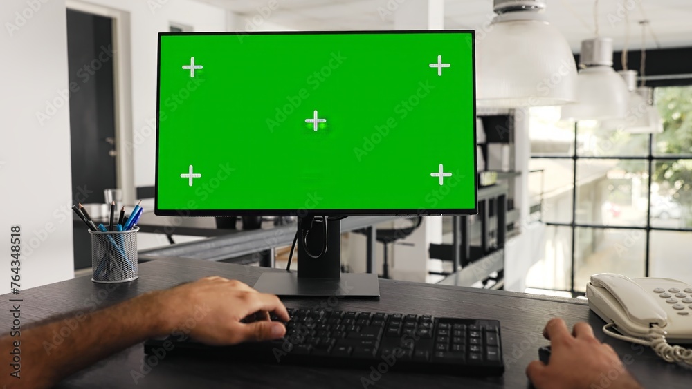 Poster pov of businessman works at greenscreen pc in front of computer, solving daily tasks and looking at 