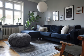 Gray poufs and dark blue sofa, modern Scandinavian vibe.